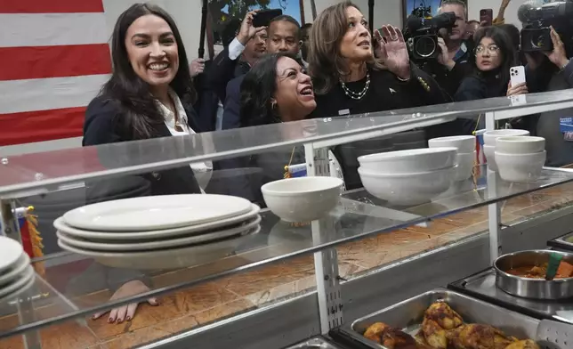 Democratic presidential nominee Vice President Kamala Harris, from right, visits Old San Juan Cafe restaurant with restaurant owner Diana de La Rosa and Rep. Alexandria Ocasio-Cortez, D-N.Y., during a campaign stop in Reading, Pa., Monday, Nov. 4, 2024. (AP Photo/Jacquelyn Martin)