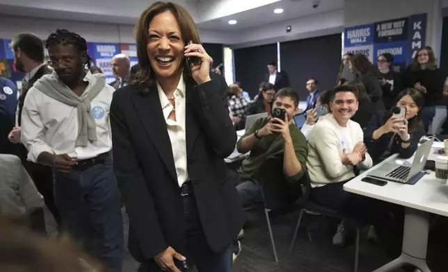 Democratic presidential nominee Vice President Kamala Harris, left, phone banks with volunteers at the DNC headquarters on Election Day, Tuesday, Nov. 5, 2024, in Washington. (AP Photo/Jacquelyn Martin)