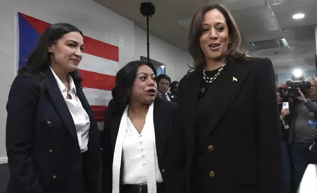 Democratic presidential nominee Vice President Kamala Harris, from right, visits Old San Juan Cafe restaurant with restaurant owner Diana de La Rosa and Rep. Alexandria Ocasio-Cortez, D-N.Y., during a campaign stop in Reading, Pa., Monday, Nov. 4, 2024. (AP Photo/Jacquelyn Martin)