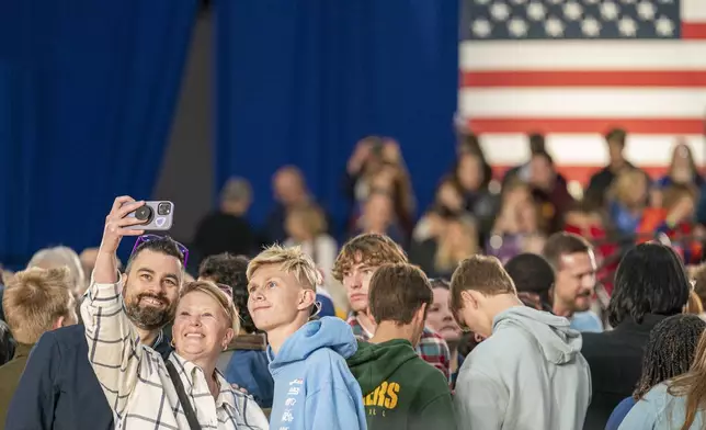 Supporters take a selfie before Democratic presidential nominee Vice President Kamala Harris speaks at a campaign event Friday, Nov. 1, 2024, in Little Chute, Wis. (AP Photo/Andy Manis)