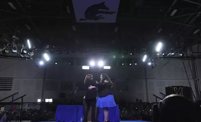 Small business owner Elizabeth Strong, right, hugs Democratic presidential nominee Vice President Kamala Harris on stage during a campaign rally in Memorial Hall at Muhlenberg College in Allentown, Pa., Monday, Nov. 4, 2024. (AP Photo/Jacquelyn Martin)