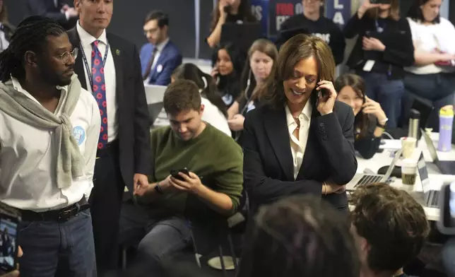 Democratic presidential nominee Vice President Kamala Harris, right, phone banks with volunteers at the DNC headquarters on Election Day, Tuesday, Nov. 5, 2024, in Washington. (AP Photo/Jacquelyn Martin)