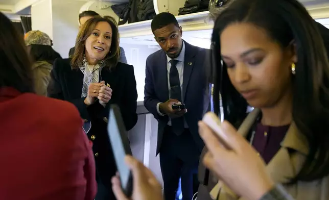 Democratic presidential nominee Vice President Kamala Harris speaks with reporters on board Air Force Two at Detroit Metropolitan Wayne County Airport in Detroit, Monday Nov. 4, 2024, before departing to Pennsylvania. (AP Photo/Jacquelyn Martin, Pool)