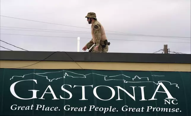 A member of law enforcement takes position before Republican presidential nominee former President Donald Trump speaks at a campaign rally in Gastonia, N.C., Saturday, Nov. 2, 2024. (AP Photo/Chris Carlson)