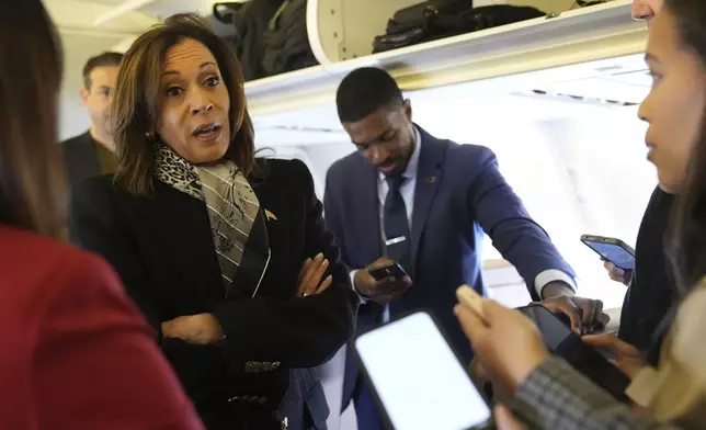 Democratic presidential nominee Vice President Kamala Harris speaks with reporters on board Air Force Two at Detroit Metropolitan Wayne County Airport in Detroit, Monday Nov. 4, 2024, before departing to Pennsylvania. (AP Photo/Jacquelyn Martin, Pool)