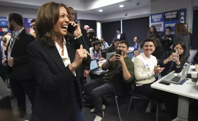 Democratic presidential nominee Vice President Kamala Harris, left, phone banks with volunteers at the DNC headquarters on Election Day, Tuesday, Nov. 5, 2024, in Washington. (AP Photo/Jacquelyn Martin)