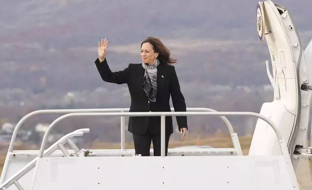 Democratic presidential nominee Vice President Kamala Harris waves as she boards Air Force Two at Wilkes-Barre Scranton International Airport in Scranton, Pa., Monday Nov. 4, 2024, en route to Allentown, Pa. (AP Photo/Jacquelyn Martin, Pool)