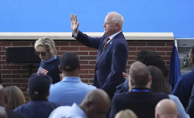 Minnesota Gov. Tim Walz waves as he arrives ahead of Vice President Kamala Harris delivering a concession speech for the 2024 presidential election, Wednesday, Nov. 6, 2024, on the campus of Howard University in Washington. (AP Photo/Stephanie Scarbrough)