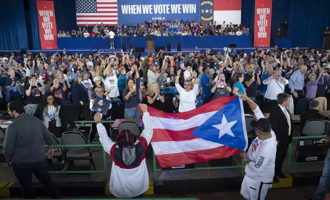 Supporters carry the Puerto Rican flag before Democratic presidential nominee Vice President Kamala Harris arrives to speak at a campaign rally, Wednesday, Oct. 30, 2024, in Raleigh, N.C. (AP Photo/Allison Joyce)