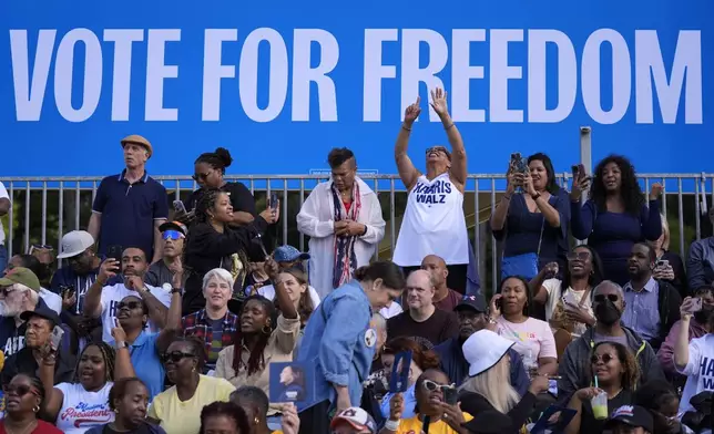 Attendees wait for Democratic presidential nominee Vice President Kamala Harris to arrive at a campaign rally outside the Atlanta Civic Center, Saturday, Nov. 2, 2024. (AP Photo/Brynn Anderson)