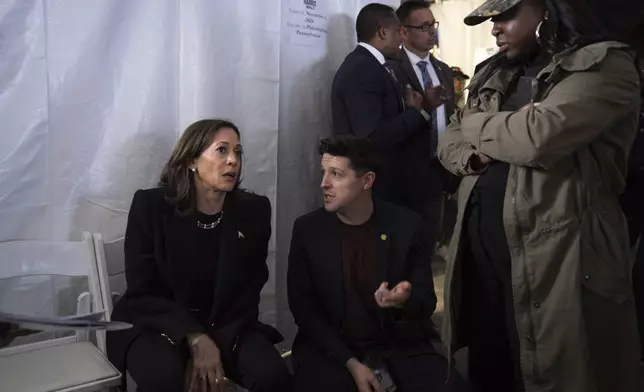 Democratic presidential nominee Vice President Kamala Harris, left, speaks with Ike Irby, senior advisor to the vice president, and Kirsten Allen, communications director to the vice president, shortly before taking the stage for Harris' final campaign rally, Monday, Nov. 4, 2024, in Philadelphia. (AP Photo/Jacquelyn Martin)