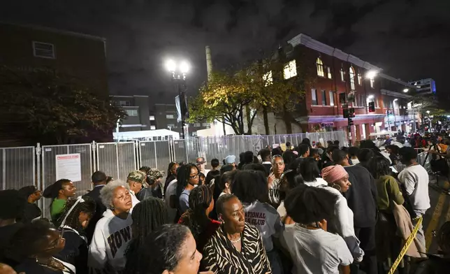 People gather near the entrance to Democratic presidential nominee Vice President Kamala Harris' election night watch party at Howard University, Tuesday, Nov. 5, 2024, in Washington. (AP Photo/Terrance Williams)