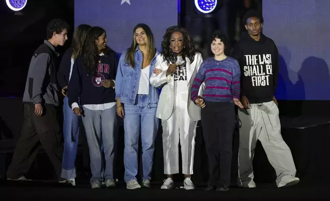 Oprah Winfrey, third from right, speaks as she stands on stage at a campaign rally supporting Democratic presidential nominee Vice President Kamala Harris outside the Philadelphia Museum of Art, Monday, Nov. 4, 2024, in Philadelphia. (AP Photo/Matt Slocum)