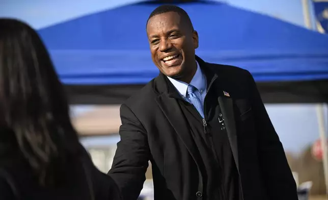 Republican U.S. House candidate George Logan, right, greets voters on Election Day, Tuesday, Nov. 5, 2024, in Brookfield, Conn. (Jessica Hill/Hartford Courant via AP)