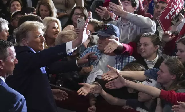 FILE - Republican presidential candidate former President Donald Trump greets supporters at a campaign rally in North Charleston, S.C., Feb. 14, 2024. (AP Photo/David Yeazell, File)