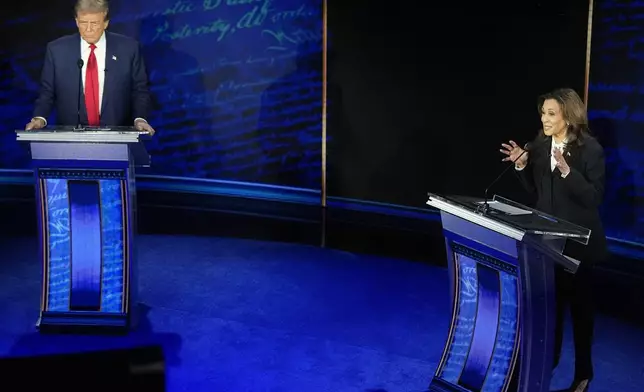 FILE - Republican presidential nominee former President Donald Trump watches as Democratic presidential nominee Vice President Kamala Harris speaks during an ABC News presidential debate, Sept. 10, 2024, in Philadelphia. (AP Photo/Alex Brandon, File)