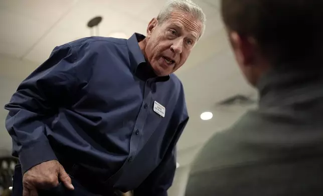 Joe McGraw, right, the Republican challenger in the 17th district, talks with Andrew Rogers, during Homebuilders Association event at Lino's restaurant in Rockford, Ill., Thursday, Oct. 17, 2024. (AP Photo/Nam Y. Huh)