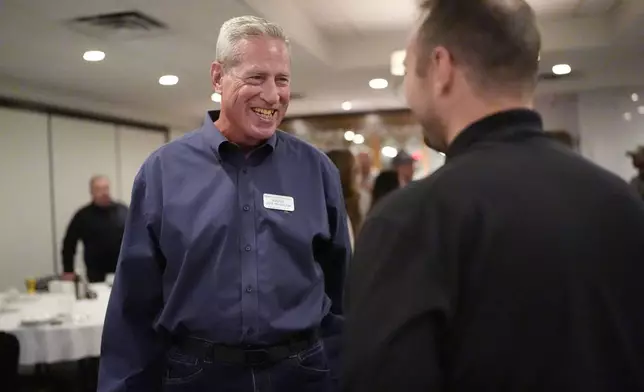 Judge Joe McGraw, left, the Republican challenger in the 17th district, talks with a member of Homebuilders Association, during Homebuilders Association event at Lino's restaurant in Rockford, Ill., Thursday, Oct. 17, 2024. (AP Photo/Nam Y. Huh)