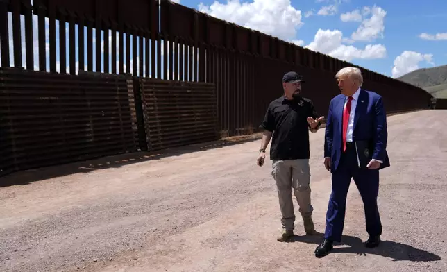 FILE - Republican presidential nominee former President Donald Trump listens to Paul Perez, president of the National Border Patrol Council, as he tours the southern border with Mexico, on Aug. 22, 2024, in Sierra Vista, Ariz. (AP Photo/Evan Vucci)