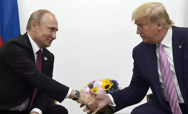 FILE - In this June 28, 2019, file photo, President Donald Trump, right, shakes hands with Russian President Vladimir Putin, left, during a bilateral meeting on the sidelines of the G-20 summit in Osaka, Japan. (AP Photo/Susan Walsh, File)