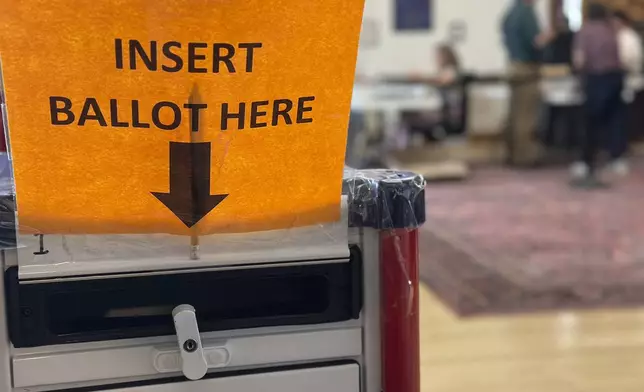 Election workers process absentee ballots at Portland City Hall on Monday, Nov. 4, 2024, in Portland, Maine. (AP Photo/David Sharp)