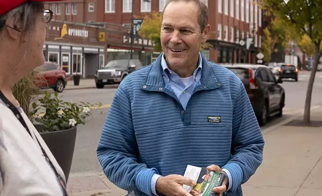 FILE - David Costello, Democratic candidate for the U.S. Senate from Maine, right, speaks with Grace Jameson, of Saco, Maine, left, on Main Street in Saco, Thursday, Oct. 3, 2024. (Gregory Rec/Portland Press Herald via AP, File)