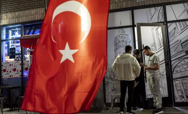 The flag of Turkey hangs as workers take a break from the dinner shift at a Turkish restaurant Wednesday, Nov. 6, 2024, in Dearborn, Mich., the nation's largest Arab-majority city. (AP Photo/David Goldman)