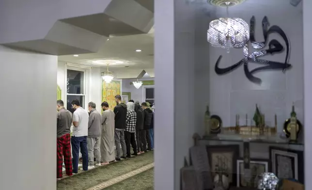 Members of the muslim community pray during morning prayers before the polls open on Election Day, Tuesday, Nov. 5, 2024, at the American Muslim Center in Dearborn, Mich., the nation's largest Arab-majority city. (AP Photo/David Goldman)