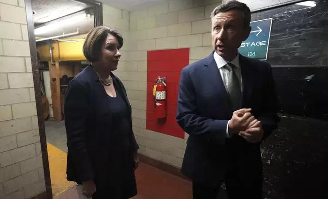 Sen. Amy Klobuchar stands with DFL Chairman Ken Martin before speaking at the DFL election night watch party, Tuesday, Nov. 5, 2024, in St. Paul, Minn. (AP Photo/Abbie Parr)