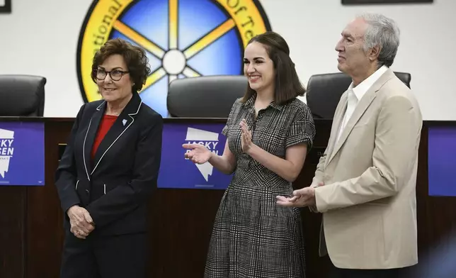 Sen. Jacky Rosen, D-Nev., is applauded by her daughter Miranda Rosen, center, and husband Larry Rosen before delivering remarks after winning re-election Saturday, Nov. 9, 2024, in Las Vegas. (Sam Morris/Las Vegas Review-Journal via AP)