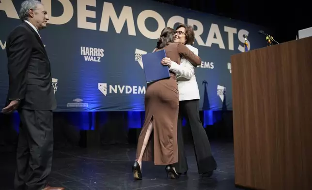 Sen. Jacky Rosen, D-Nev., hugs her daughter Miranda Rosen as her husband Larry Rosen, left, looks on during an election watch party Wednesday, Nov. 6, 2024, in Las Vegas. (AP Photo/John Locher)