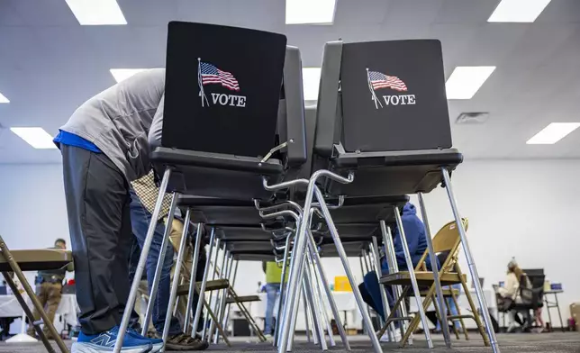 Voters cast their ballots at the Your Vote Center in the Andalucia Shopping Center on Election Day, Tuesday, Nov. 5, 2024, in Albuquerque, N.M. (Gino Gutierrez/The Albuquerque Journal via AP)