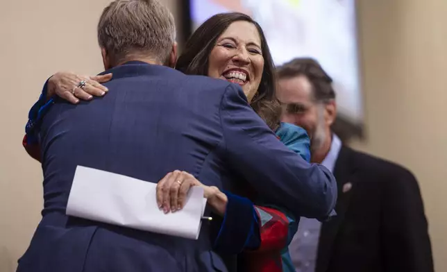 Democratic congresswoman Teresa Leger Fernández hugs Mayor Tim Keller as she takes the stage during the Democratic Party of New Mexico Election Night Watch Party at the Isleta Casino and Resort in Albuquerque, N.M., on Tuesday, Nov. 5, 2024. (Chancey Bush/The Albuquerque Journal via AP)