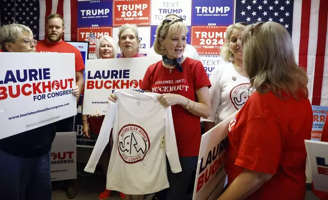 FILE - Congressional candidate Laurie Buckhout, R-N.C., second from right, speaks to a supporter prior to a staff photo at the Nash County Republican headquarters in Rocky Mount, N.C., Sept. 20, 2024. (AP Photo/Karl B DeBlaker, File)