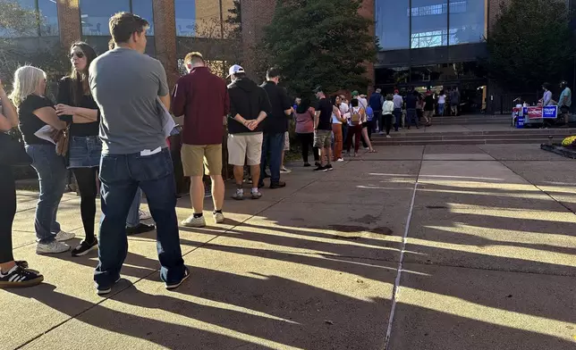 Voters line up outside the Bucks County Administration Building during early voting in the general election, Friday, Nov. 1, 2024, in Doylestown, Pa. (AP Photo/Michael Rubinkam)