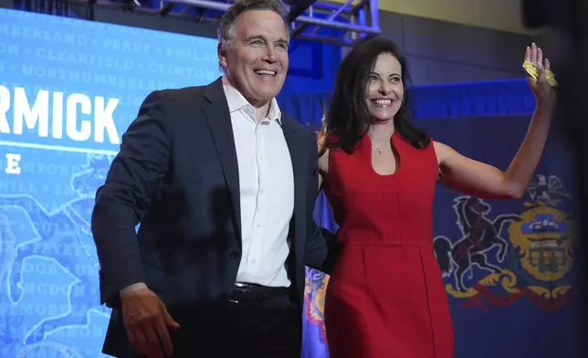 Republican Pennsylvania Senate candidate David McCormick, left, arrives to speak with his wife, Dina Powell, during an election night watch party, Wednesday, Nov. 6, 2024, in Pittsburgh. (AP Photo/Gene J. Puskar)