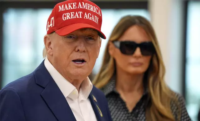 Republican presidential nominee former President Donald Trump speaks as former first lady Melania Trump listens after they voted on Election Day at the Morton and Barbara Mandel Recreation Center, Tuesday, Nov. 5, 2024, in Palm Beach, Fla. (AP Photo/Evan Vucci)