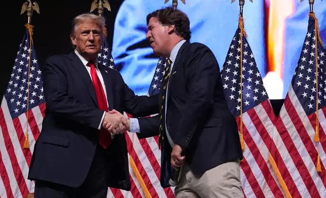 Republican presidential nominee former President Donald Trump speaks with Tucker Carlson during a Tucker Carlson Live Tour show at Desert Diamond Arena, Thursday, Oct. 31, 2024, in Glendale, Ariz. (AP Photo/Julia Demaree Nikhinson)