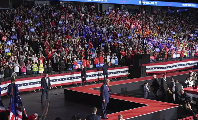 Republican presidential nominee former President Donald Trump arrives at a campaign rally at Van Andel Arena, Tuesday, Nov. 5, 2024, in Grand Rapids, Mich. (AP Photo/Paul Sancya)