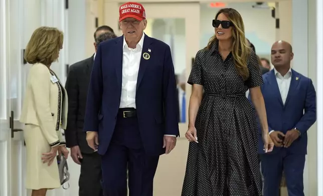 Republican presidential nominee former President Donald Trump and former first lady Melania Trump walk after voting on Election Day at the Morton and Barbara Mandel Recreation Center, Tuesday, Nov. 5, 2024, in Palm Beach, Fla. (AP Photo/Evan Vucci)