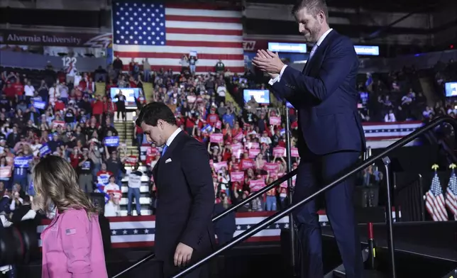 From left, Lara Trump, Michael Boulos, and Eric Trump leave the stage as Republican presidential nominee former President Donald Trump speaks during a campaign rally at Santander Arena, Monday, Nov. 4, 2024, in Reading, Pa. (AP Photo/Evan Vucci)