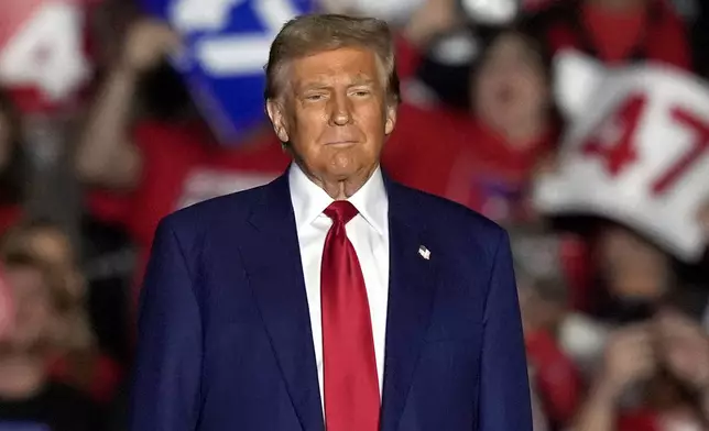 Republican presidential nominee former President Donald Trump arrives to speak at a campaign rally at the Suburban Collection Showplace, Saturday, Oct. 26, 2024 in Novi, Mich. (AP Photo/Carlos Osorio)