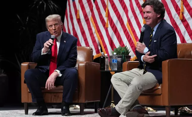 Republican presidential nominee former President Donald Trump speaks with Tucker Carlson during a Tucker Carlson Live Tour show at Desert Diamond Arena, Thursday, Oct. 31, 2024, in Glendale, Ariz. (AP Photo/Julia Demaree Nikhinson)