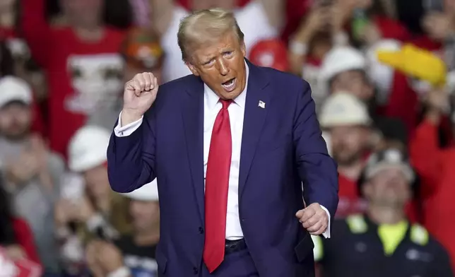 Republican presidential nominee former President Donald Trump dances after speaking at a campaign rally at PPG Paints Arena, Monday, Nov. 4, 2024, in Pittsburgh. (AP Photo/Matt Freed)