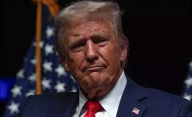 Republican presidential nominee former President Donald Trump listens during a Tucker Carlson Live Tour show at Desert Diamond Arena, Thursday, Oct. 31, 2024, in Glendale, Ariz. (AP Photo/Julia Demaree Nikhinson)