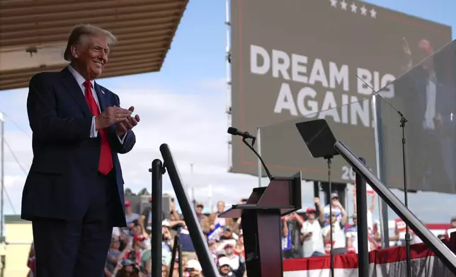 Republican presidential nominee former President Donald Trump smiles at a campaign rally at Gastonia Municipal Airport, Saturday, Nov. 2, 2024, in Gastonia, N.C. (AP Photo/Evan Vucci)