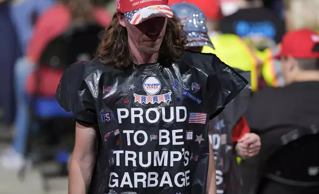 Supporters wearing garbage bags, arrive for a campaign rally for Republican presidential nominee former President Donald Trump, at First Horizon Coliseum, Saturday, Nov. 2, 2024, in Greensboro, NC. (AP Photo/Alex Brandon)