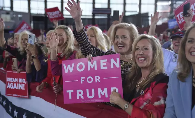 Women for Republican presidential nominee former President Donald Trump show their support as he arrives to speak during a campaign rally at J.S. Dorton Arena, Monday, Nov. 4, 2024, in Raleigh, N.C. (AP Photo/Evan Vucci)