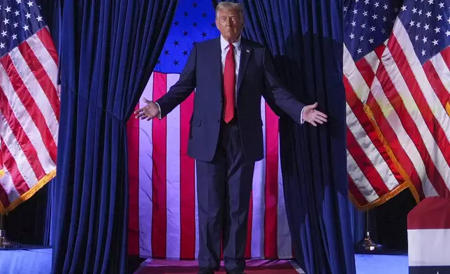 Republican presidential nominee former President Donald Trump arrives at a campaign rally at Van Andel Arena, Tuesday, Nov. 5, 2024, in Grand Rapids, Mich. (AP Photo/Evan Vucci)