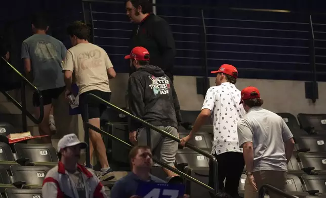 Supporters leave as Republican presidential nominee former President Donald Trump speaks at a campaign rally at McCamish Pavilion Monday, Oct. 28, 2024, in Atlanta. (AP Photo/Mike Stewart)